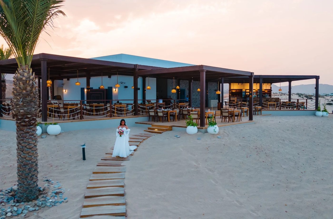 Jebel Sifah — beachfront restaurant at dusk