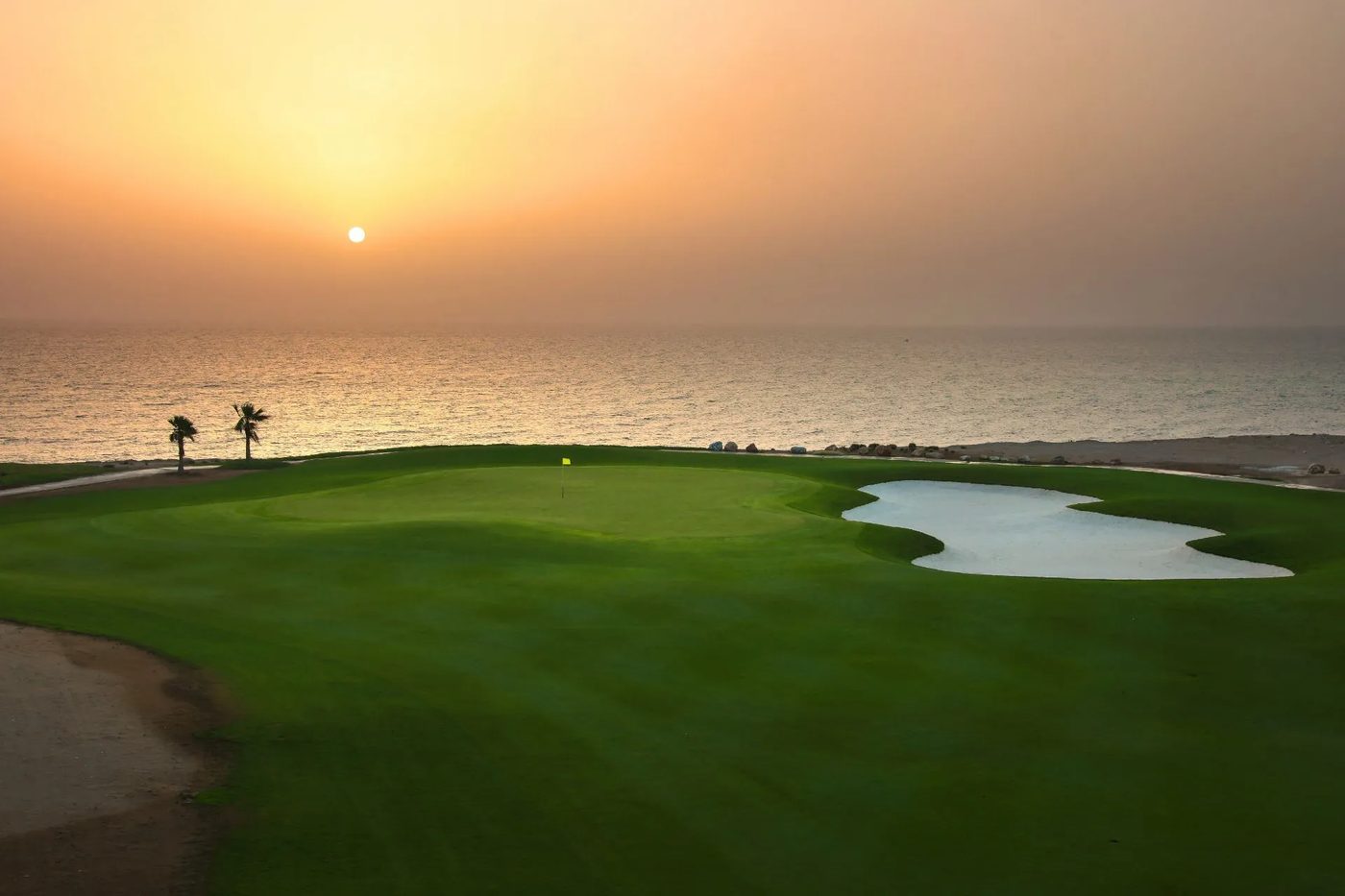Jebel Sifah — golf course by the sea at sunset