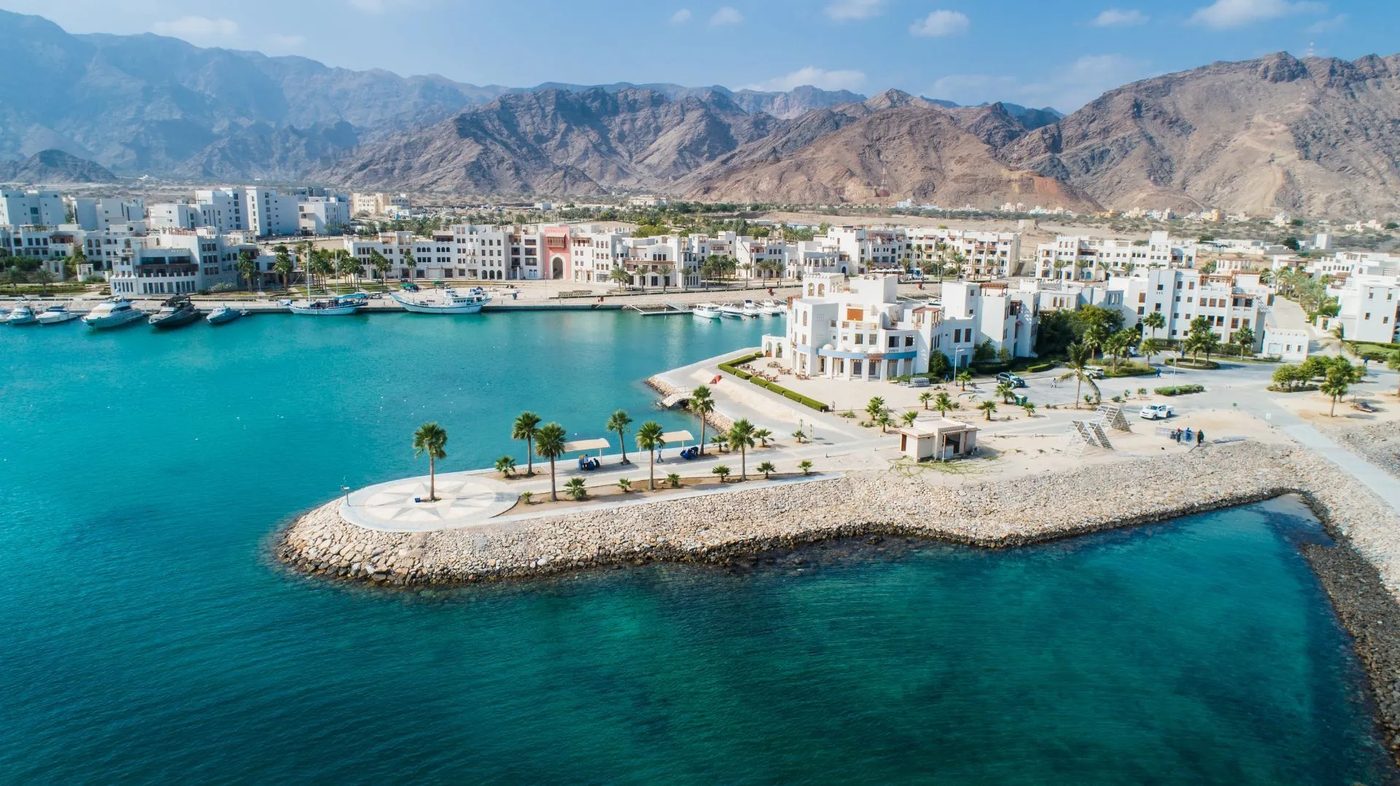 Jebel Sifah — marina promontory and the Hajar Mountains