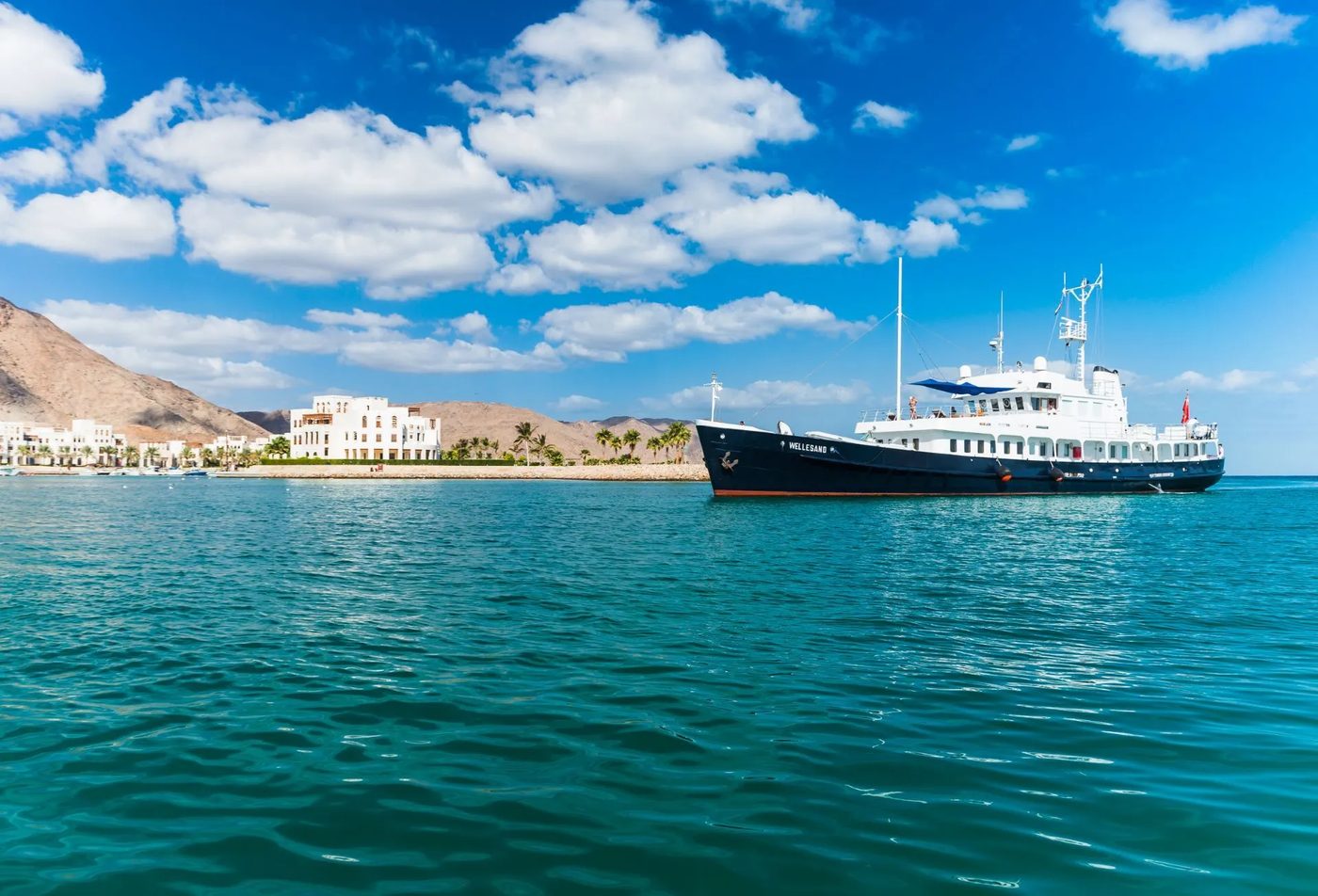 Jebel Sifah — yacht in the turquoise bay