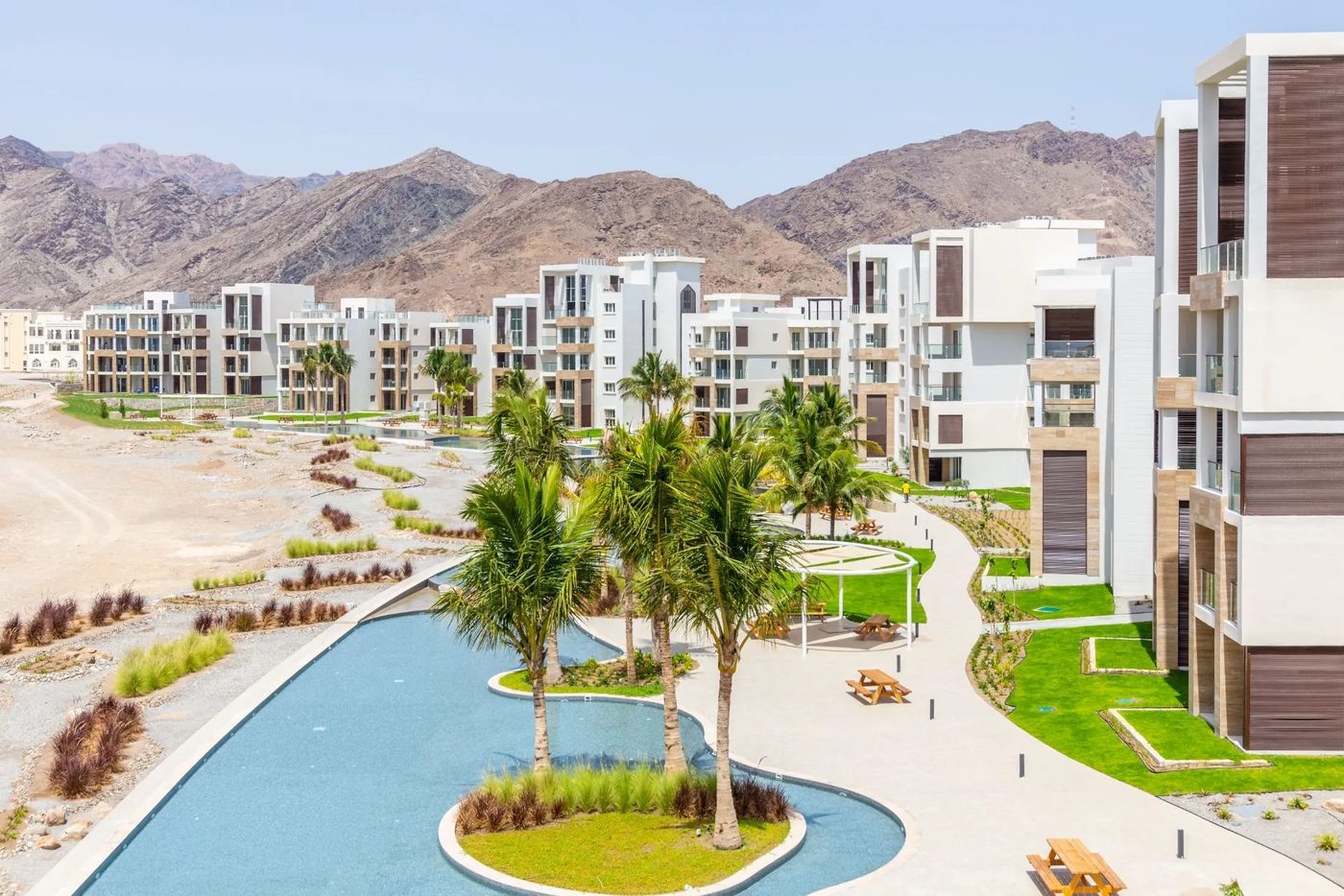 Jebel Sifah — apartments and water feature below the mountains